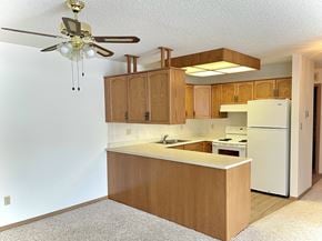 Edmonton apartment for rent - an empty kitchen with an island and a ceiling fan
