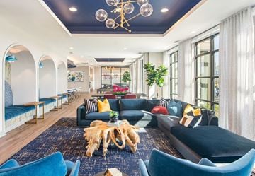 Georgetown apartment for rent - a living room with blue couches and chairs and a chandelier