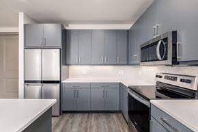 Georgetown apartment for rent - a kitchen with stainless steel appliances and white counter tops