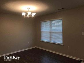 Charlotte house for rent - a empty room with a window and a chandelier