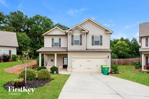 Winder house for rent - a beige house with a white garage door