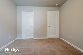 Winder house for rent - a bedroom with two doors and a carpeted floor