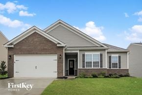 Charlotte house for rent - a beige and brown house with a white garage door