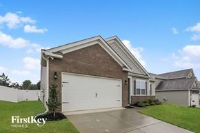Charlotte house for rent - a house with a white garage door and a lawn
