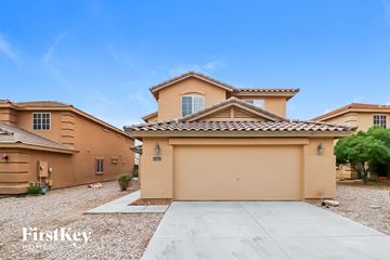 Buckeye house for rent - a beige house with a garage and a driveway