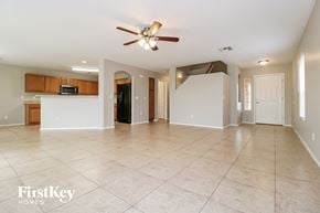 Buckeye house for rent - an empty kitchen and living room with a ceiling fan
