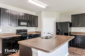 Zephyrhills house for rent - a kitchen with black appliances and a granite counter top