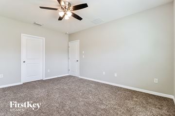 Zephyrhills house for rent - the spacious living room with ceiling fan and carpet