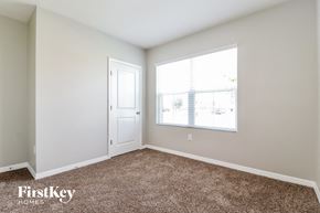 Zephyrhills house for rent - a bedroom with carpet and a window and a door
