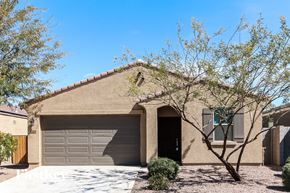 Tolleson house for rent - a house with a garage door and a tree