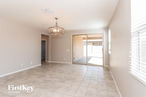 Tolleson house for rent - an empty hallway with a large window and a door into a house