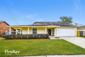 Jacksonville house for rent - A yellow house with a white garage door is for sale.