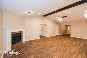 Jacksonville house for rent - A spacious room with a fireplace and wooden flooring.