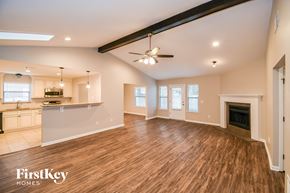 Jacksonville house for rent - A spacious living room with wooden floors and a fireplace.