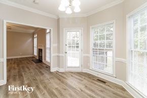 Greensboro house for rent - the living room and dining room of a house with wood flooring