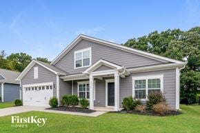 Charlotte house for rent - a gray house with a white garage door and a lawn