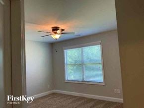 Clermont house for rent - a bedroom with a ceiling fan and a window