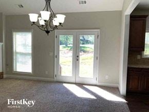 Clermont house for rent - a living room with a door and a chandelier