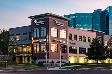 Middleton apartment for rent - The exterior of the Robertson Clinic building is shown at dusk.