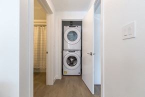 Winnipeg apartment for rent - A washing machine is in a small laundry room.