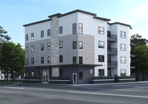 Winnipeg apartment for rent - A modern apartment building with a grey and white facade.