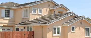 Santa Maria apartment for rent - A two-story house with a brown fence in front.