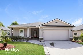Jacksonville house for rent - A house with a garage and a driveway in front of it.
