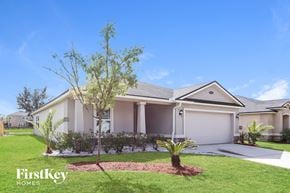 Jacksonville house for rent - A house with a tree in front of it and the words "FirstKey Homes" on the bottom left.