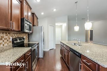 Jacksonville house for rent - A kitchen with brown cabinets and granite countertops.