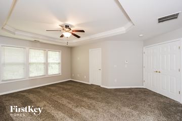 Lithia Springs house for rent - a living room with carpet and a ceiling fan
