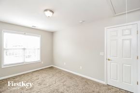Lithia Springs house for rent - a bedroom with white door and carpet and a window