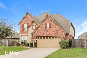 Richmond house for rent - a brick house with a brown garage door