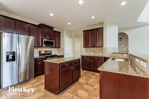 Richmond house for rent - a large kitchen with stainless steel appliances and granite counter tops