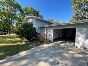 Fargo apartment for rent - a white house with a driveway and a garage door