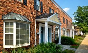 Fairfax townhouse for rent - A row of houses with a brick facade and white trim.
