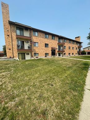 Fargo apartment for rent - a large brick apartment building with a green lawn