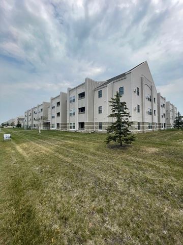 Fargo apartment for rent - a view of the exterior of an apartment building on a grass field