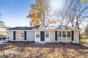 Winston Salem house for rent - a small white house with windows and a black door