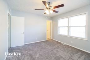 Winston Salem house for rent - a living room with a ceiling fan and a large window