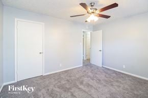 Winston Salem house for rent - a bedroom with white walls and a ceiling fan