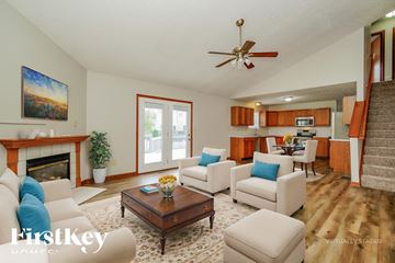 Westerville house for rent - A living room with a fireplace and a painting on the wall.