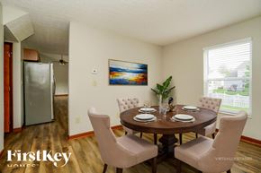 Westerville house for rent - A dining room with a wooden table and chairs.