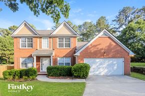 Atlanta house for rent - a brick house with a garage and a white garage door