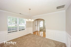 Atlanta house for rent - a dining room with white walls and a large window