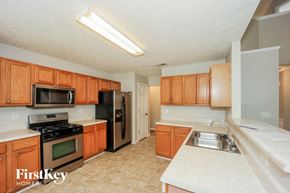 Atlanta house for rent - a kitchen with wooden cabinets and stainless steel appliances