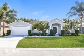Winter Haven house for rent - a white house with palm trees in front of it