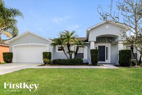 Winter Haven house for rent - a white house with palm trees in front of it