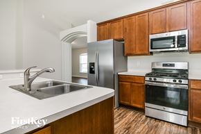 Winter Haven house for rent - a kitchen with wooden cabinets and stainless steel appliances and a sink