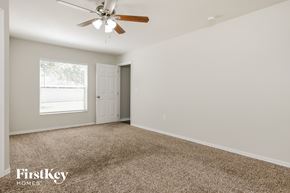 Winter Haven house for rent - a bedroom with carpet and a ceiling fan