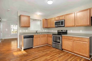 Jacksonville house for rent - A kitchen with wooden cabinets and stainless steel appliances.